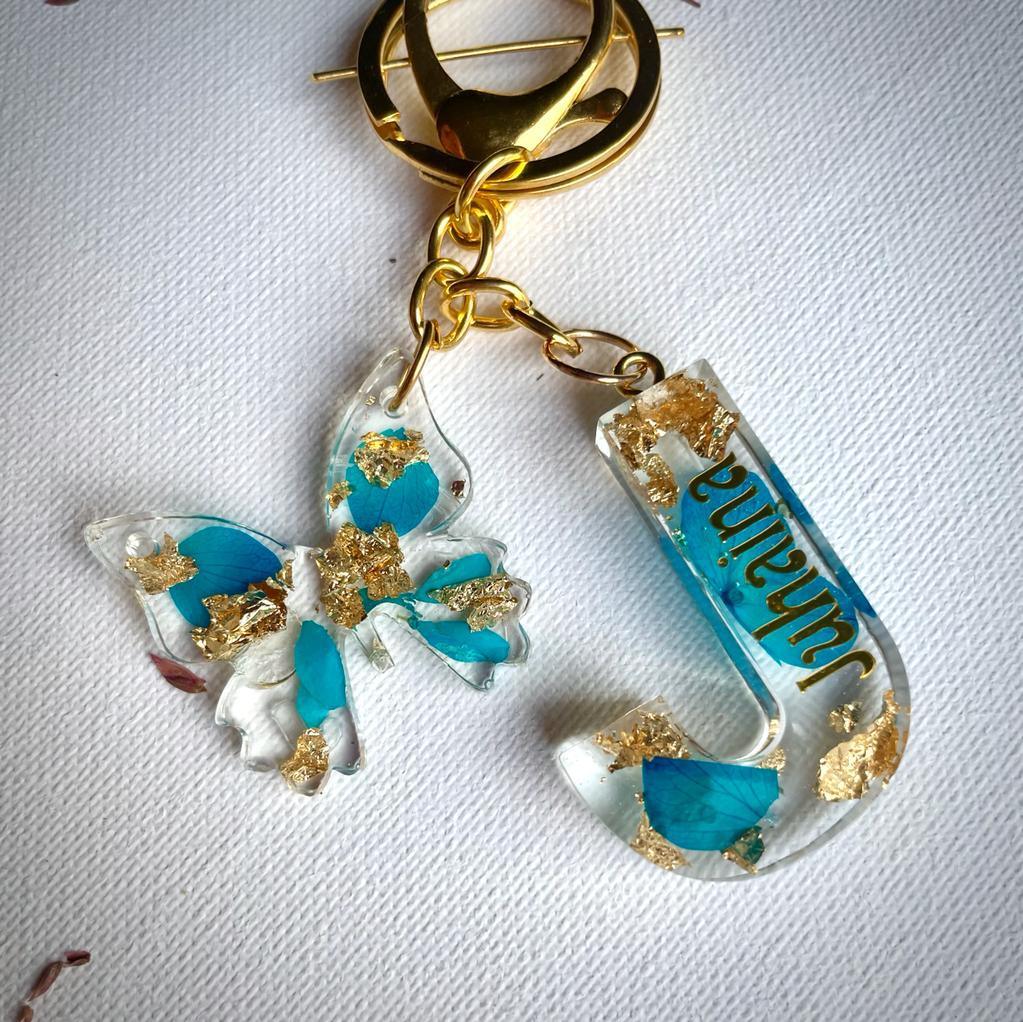 Full view of Alphabet Resin key chain with letter J and a butterfly