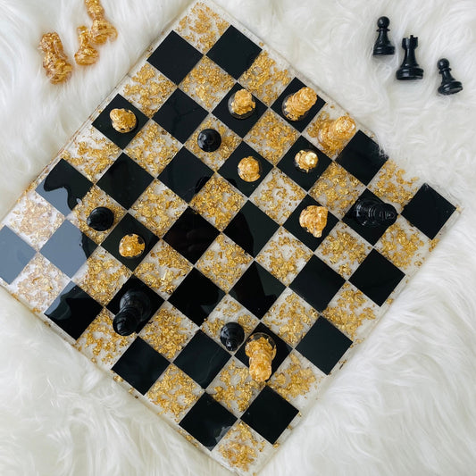 
"Top view of a handcrafted chess board featuring a glossy epoxy resin finish with alternating dark and light squares. The chess board's smooth, polished surface reflects light, highlighting intricate details in the resin pattern. The wooden edges frame the board, providing a warm contrast to the sleek resin, blending art and functionality seamlessly."