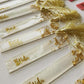 Side view of gold-colored geode-themed resin bookmarks arranged together on a tabletop, highlighting their intricate patterns and glossy epoxy finish.