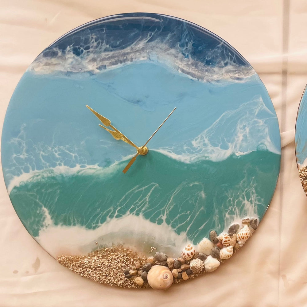 "Top view of an ocean-themed resin clock with swirling blue and white wave patterns, displayed on a wooden table surface."