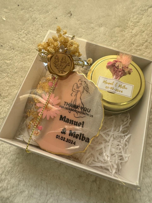 Top view of a resin with candle gift box by Hyacinth Resin Arts, showcasing a round resin piece beside a peony-shaped candle. Both items are arranged neatly inside the box, highlighting their craftsmanship and thoughtful presentation. Ideal for gifting and customization.