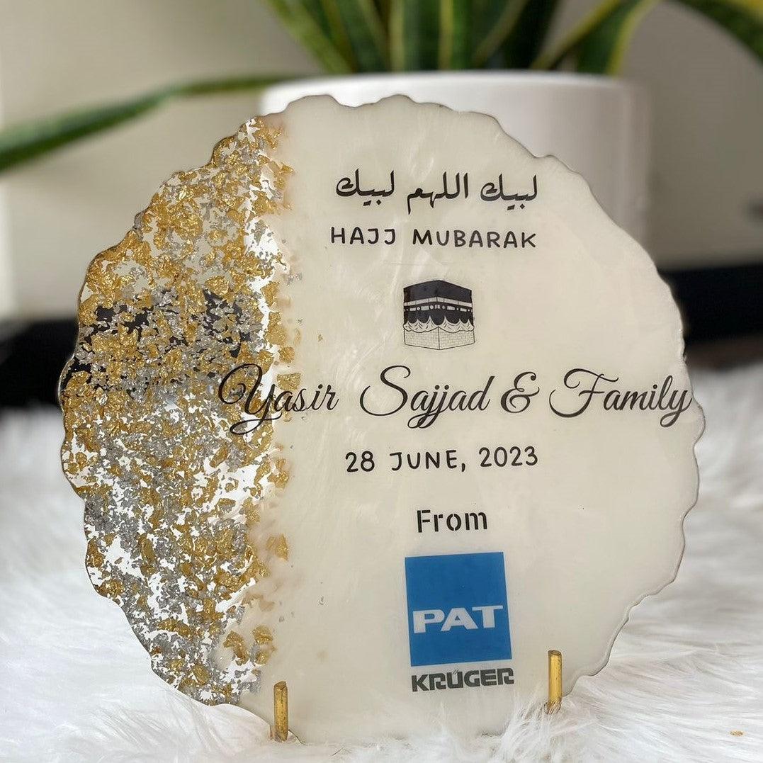 "Front view of a white and gold wedding and anniversary resin coaster displayed on a stand, set against a soft white surface, highlighting its elegant and celebratory design."